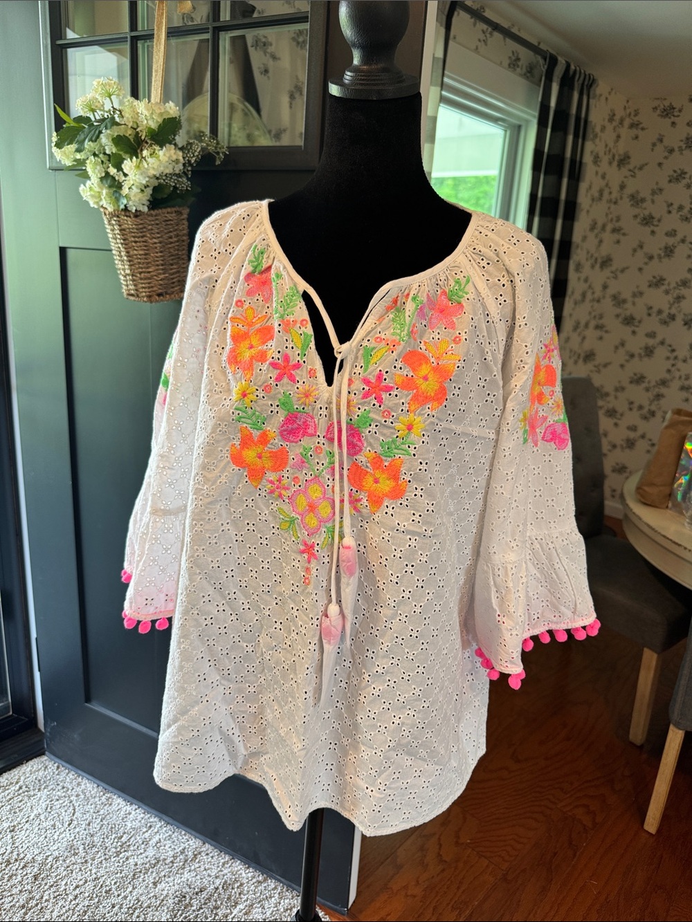 Lilly Pulitzer Morgain eyelet top featuring neon floral embroidery and pom-pom